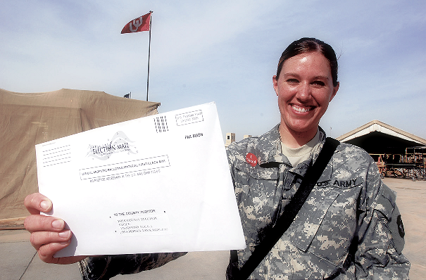 Picture of woman in military with absentee ballot