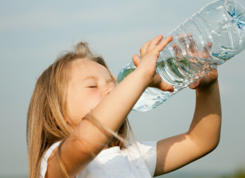 Photo of Girl Drinking Bottled Water.